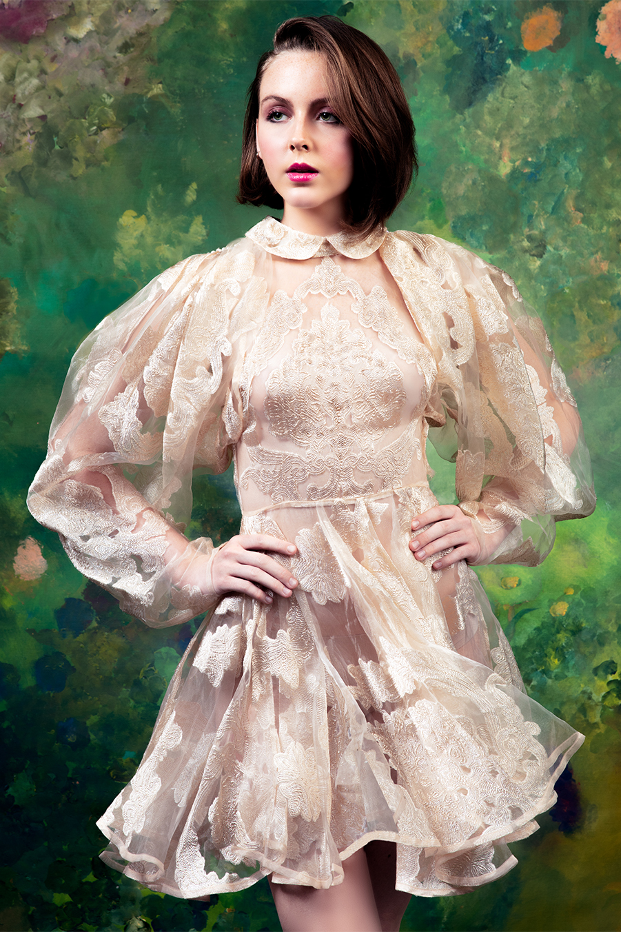 model-portfolio-session-couture-dress-photographer-gerard-harrison-houston-texas A beautiful model poses in a couture gown of champagne lace in front of an impressionist floral mural. Model portfolio photo by Gerard Harrison, photographer, Houston, Texas.