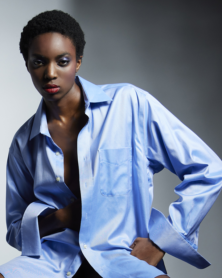 Portfolio photo of black female model in menls blue French cuffed dress shirt.