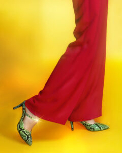 Woman's legs, flowing red pants, snakeskin pumps for a romantic fashion campaign