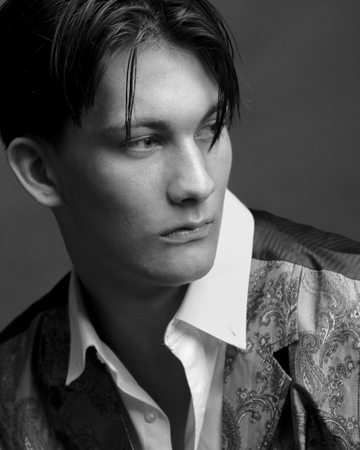 Black and white male model/actor headshot; serious off camera gaze. Gerard Harrison, Houston fashion photographer.