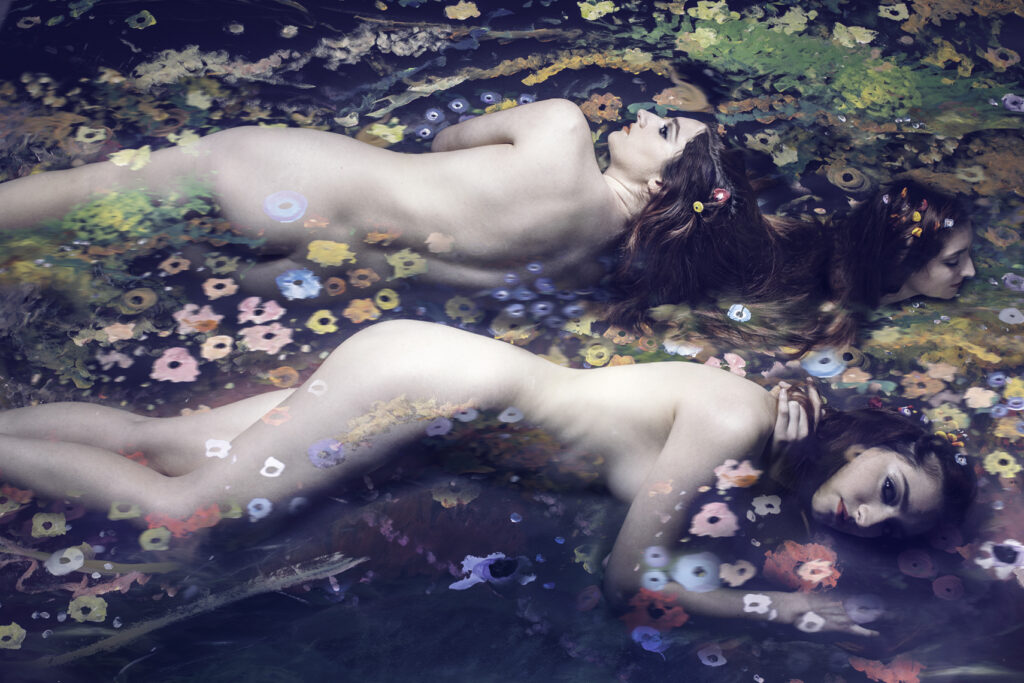 Les Naïades (after Klimt). Water spirits floating in a stream filled with flowers. A composite photograph merging an abstract painting with photography. Gerard Harrison, fine art photographer, Houston, Texas.