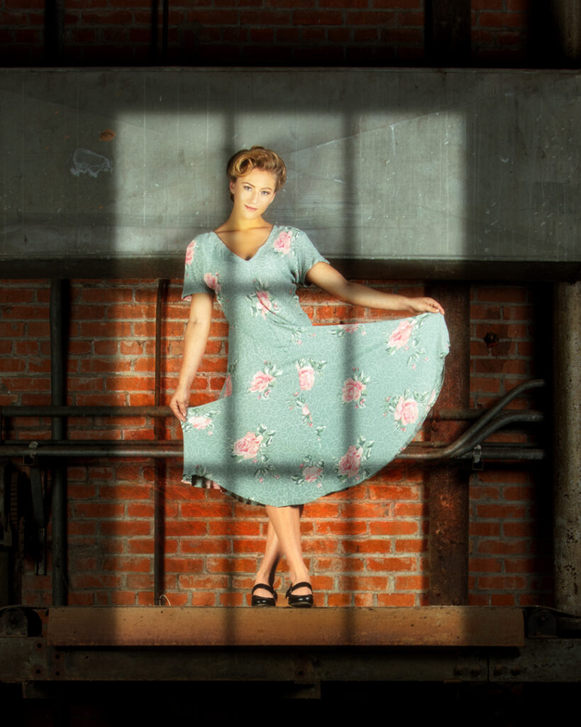 Vintage Sugar - fashion editorial. Model in 1940s dress stands on conveyer belt of abandoned sugar mill. Gerard Harrison Houston fashion photographer. Model Brenna Smith